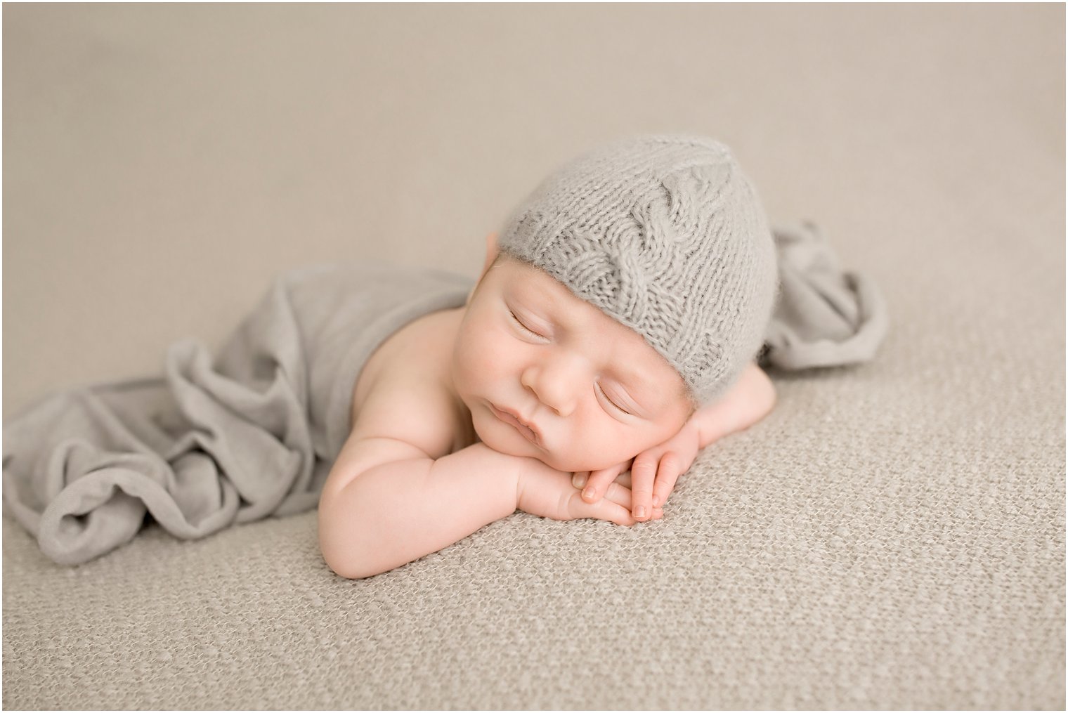 Newborn boy with gray hat and blanket | Photo by Idalia Photography