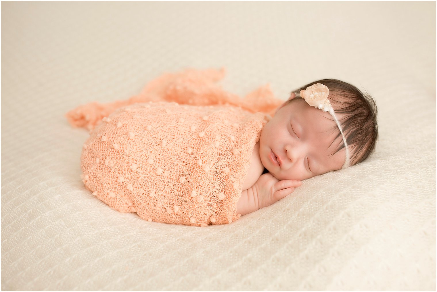 Baby girl in peach blanket | Photo by Idalia Photography