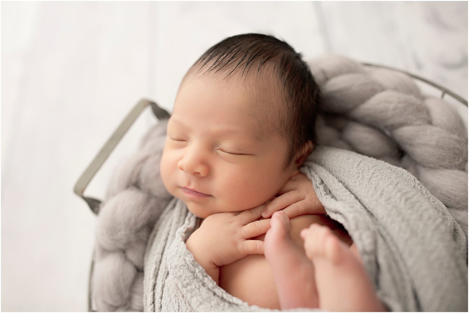 Newborn boy with gray blankets | Photo by Idalia Photography