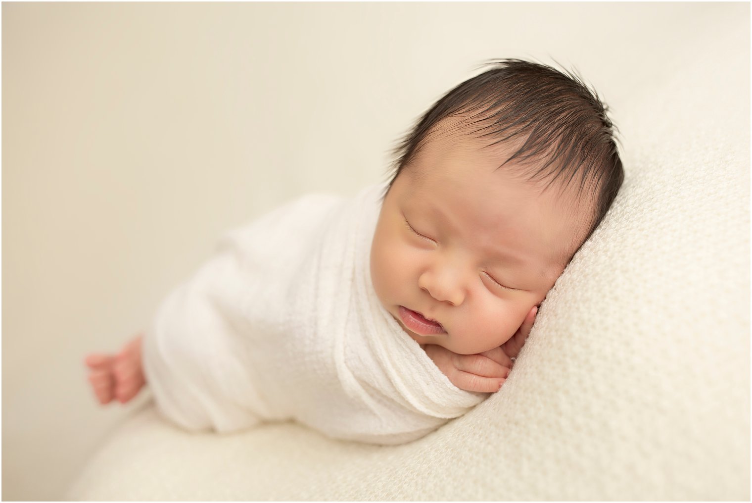 Baby boy in white wrap | Photo by Idalia Photography