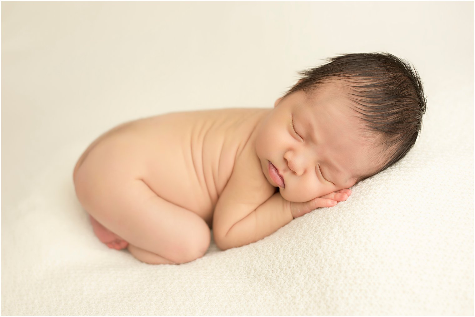 Newborn boy in tushie up pose | Photo by Idalia Photography