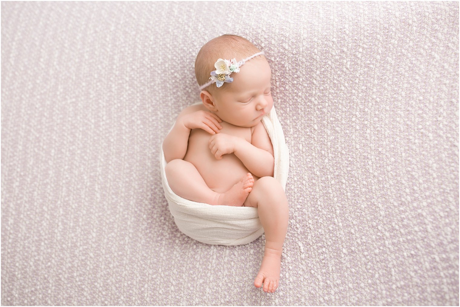 Newborn girl in lavender set-up