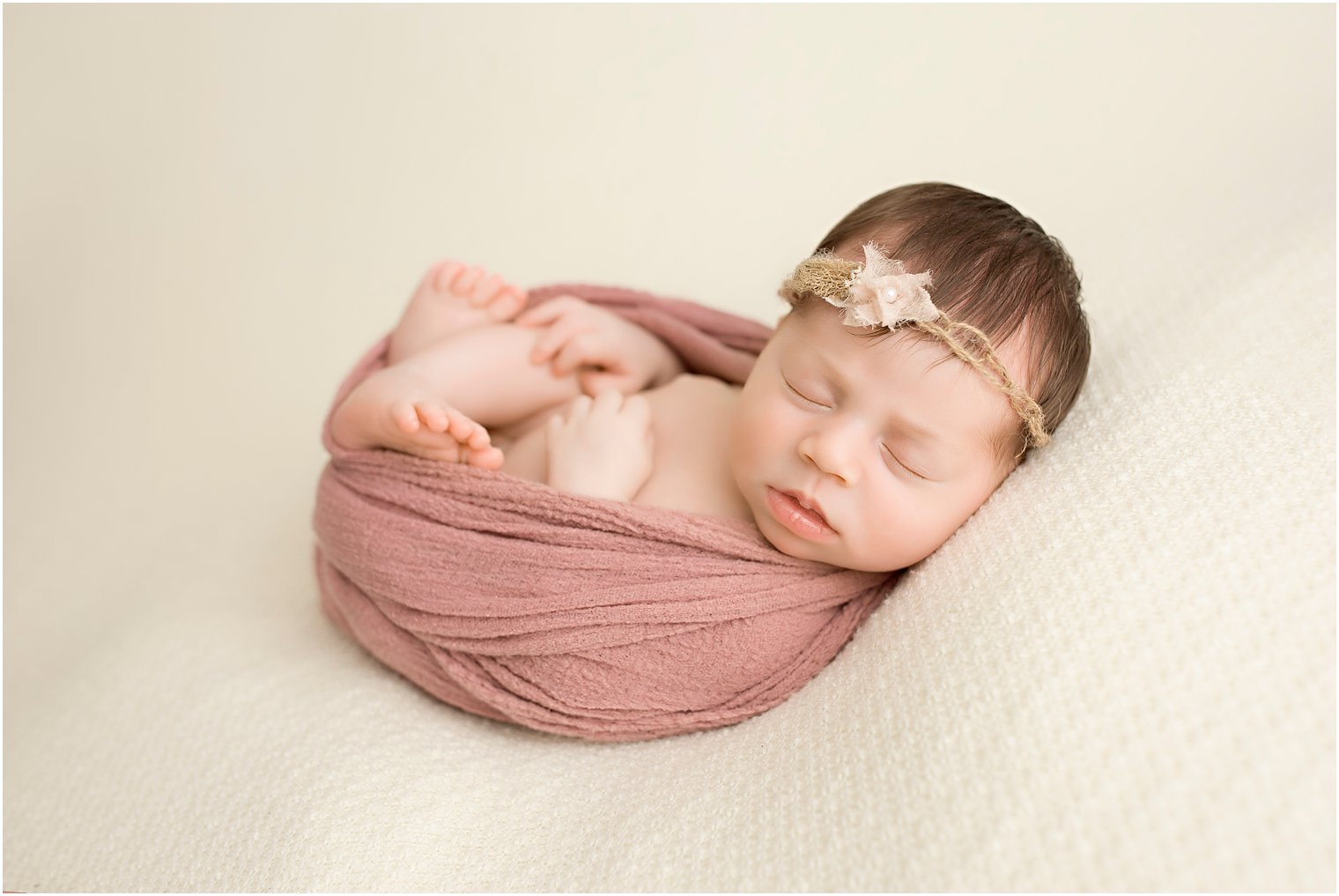 Newborn girl in Huck Finn newborn pose