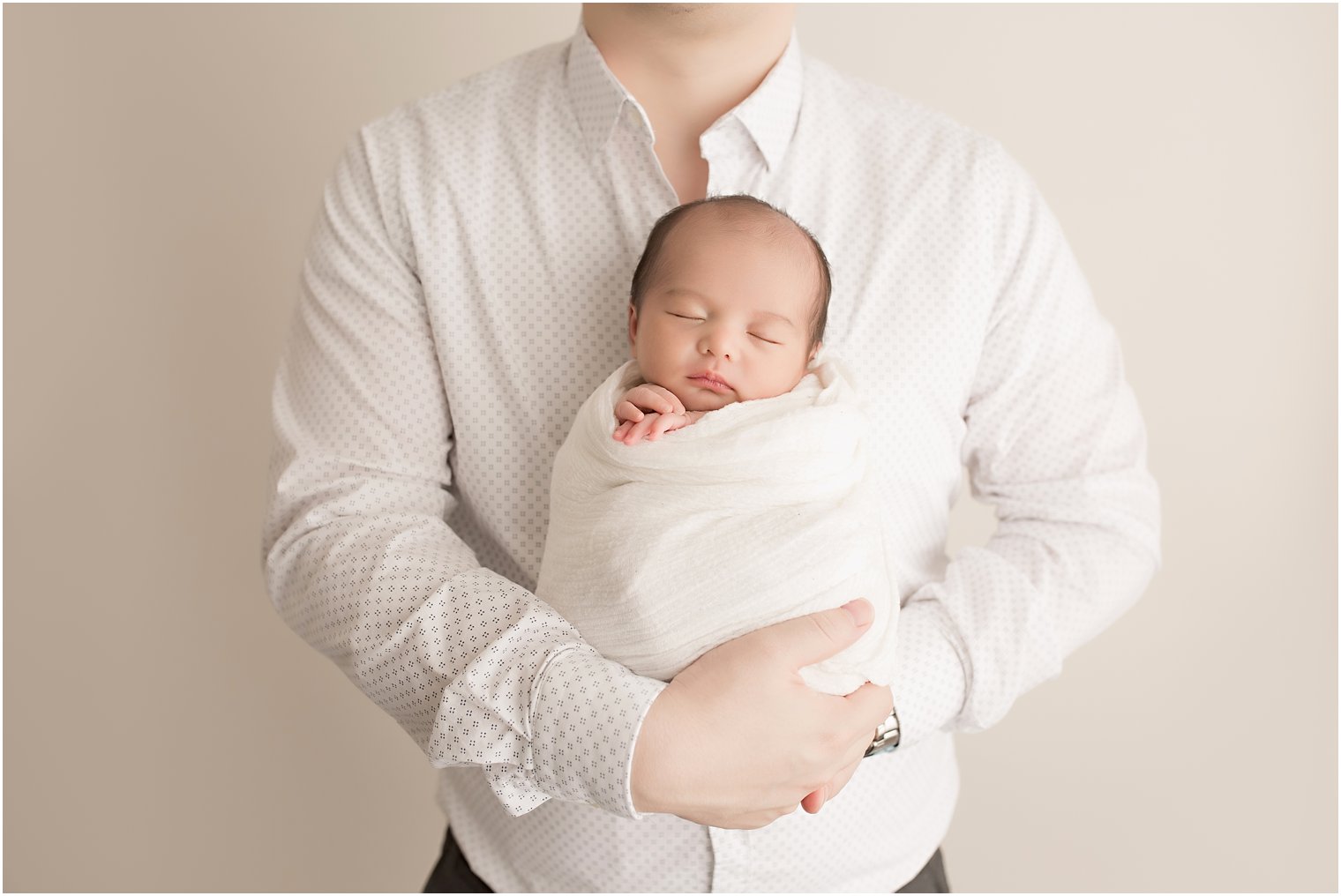Newborn girl in daddy's arms