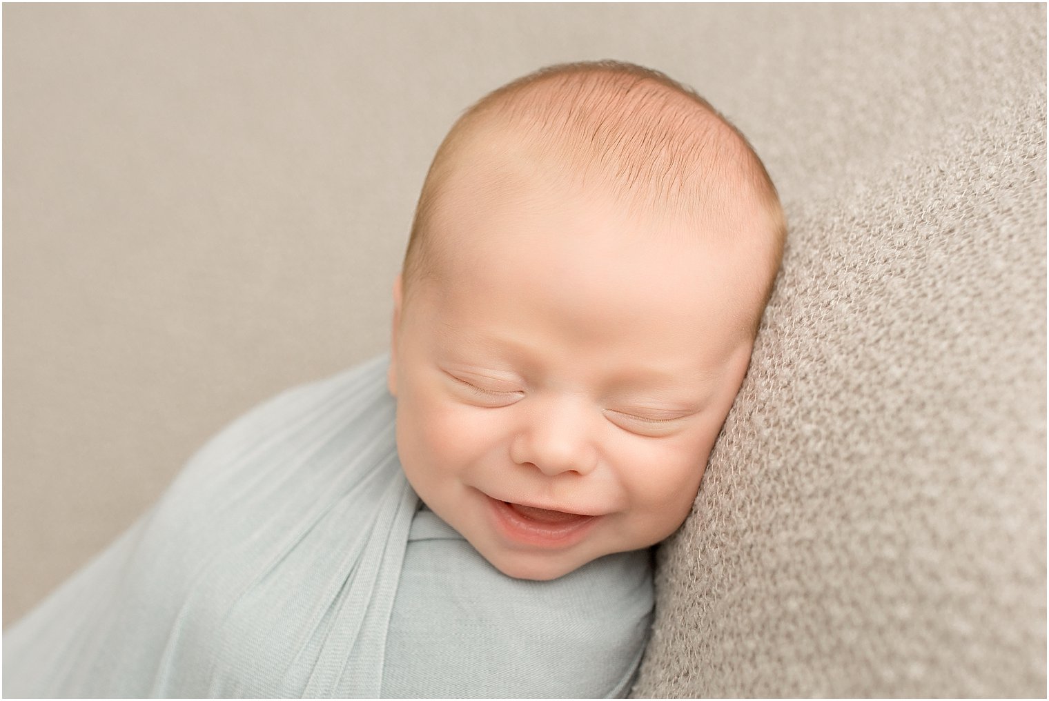 Smiling boy in newborn photo