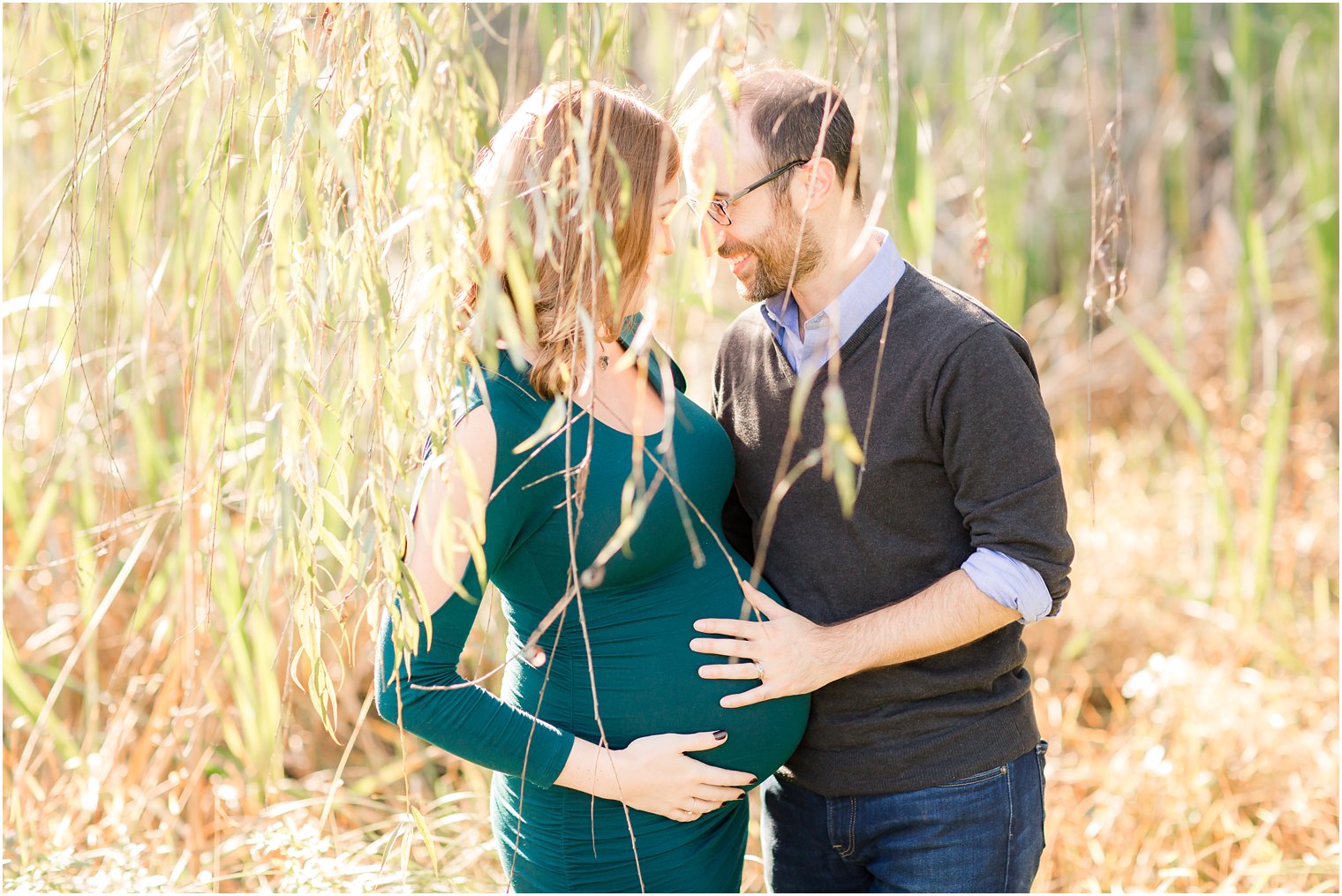Romantic maternity photo in willow trees