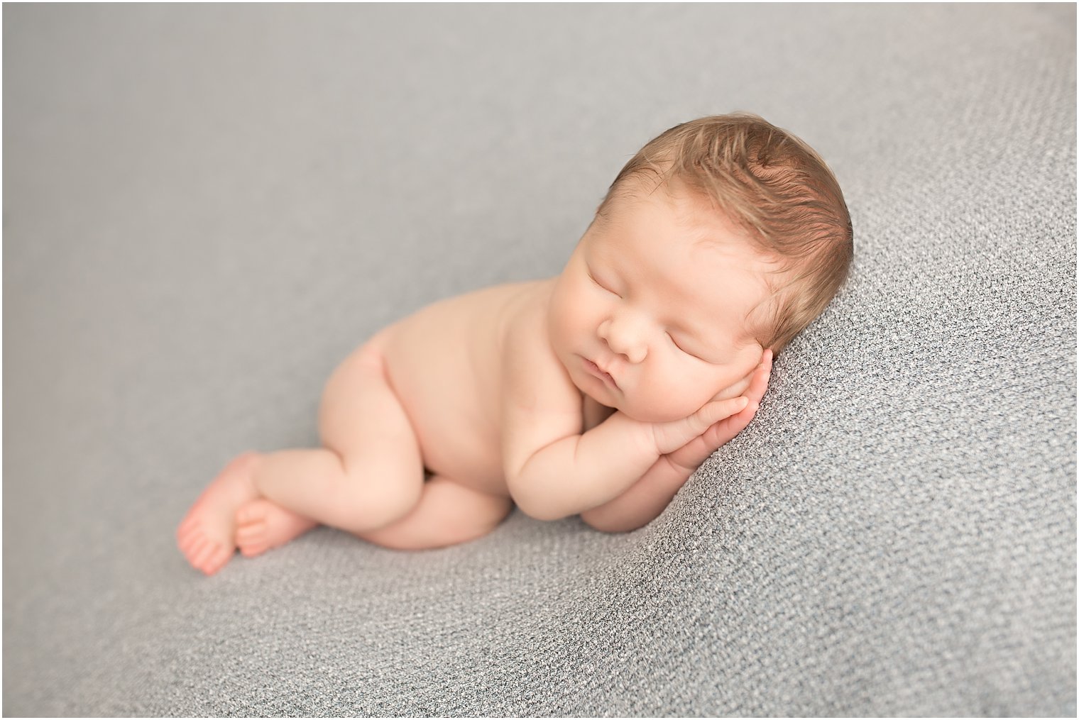 Newborn boy in side-lying pose
