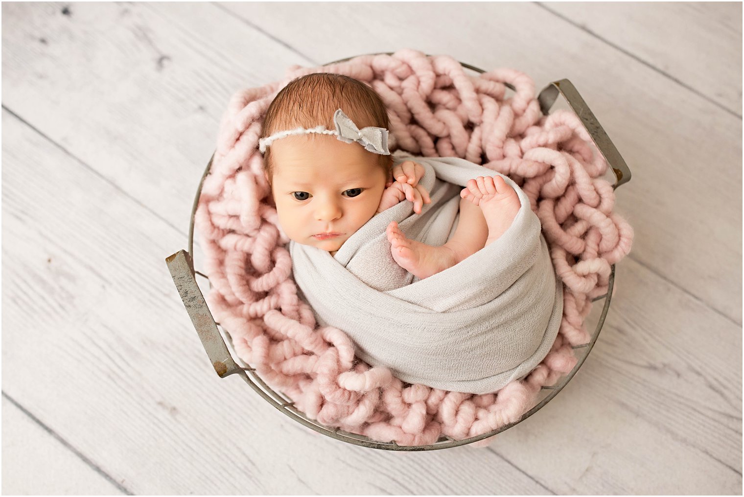 Newborn girl in gray and pink 
