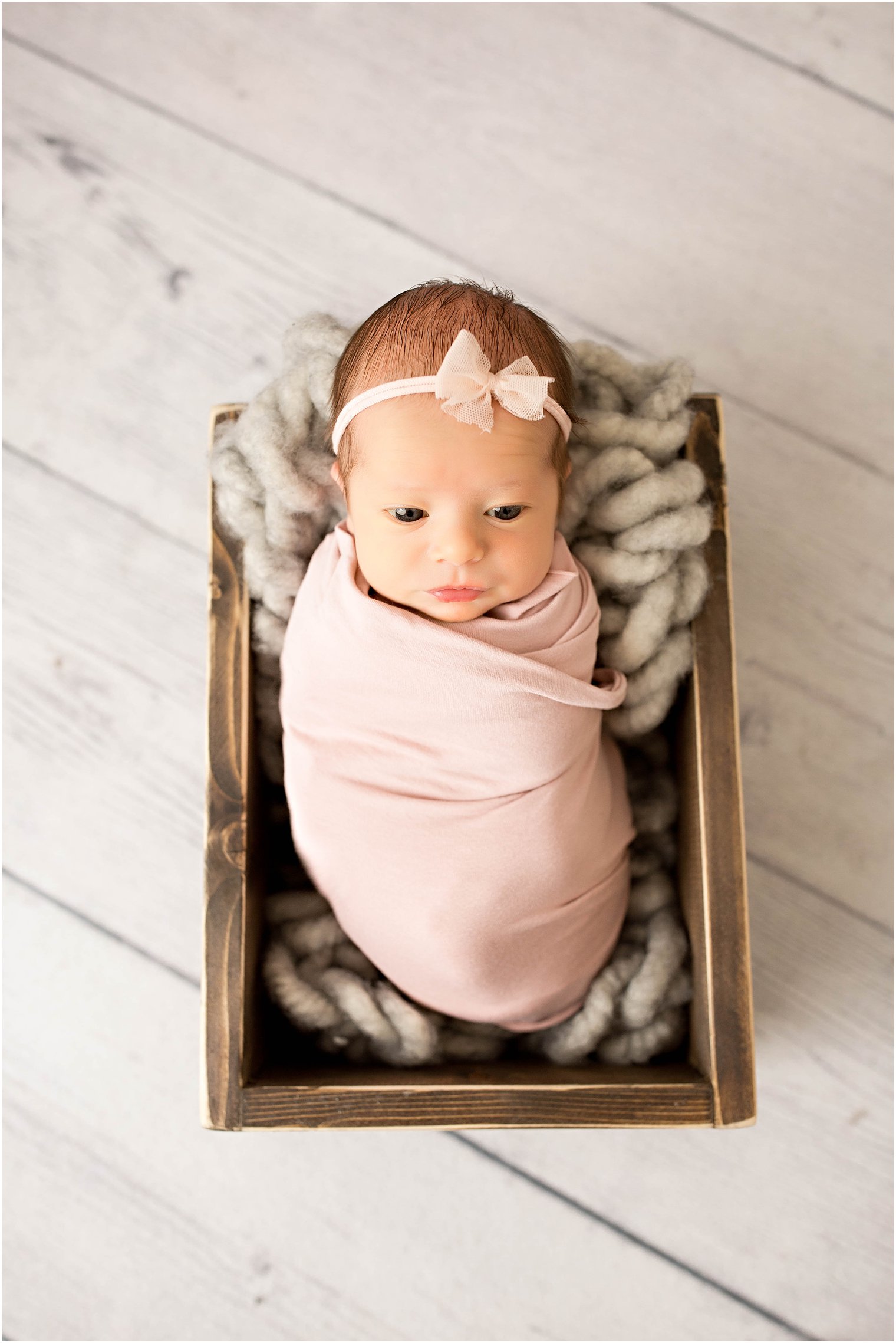 Newborn girl in a crate