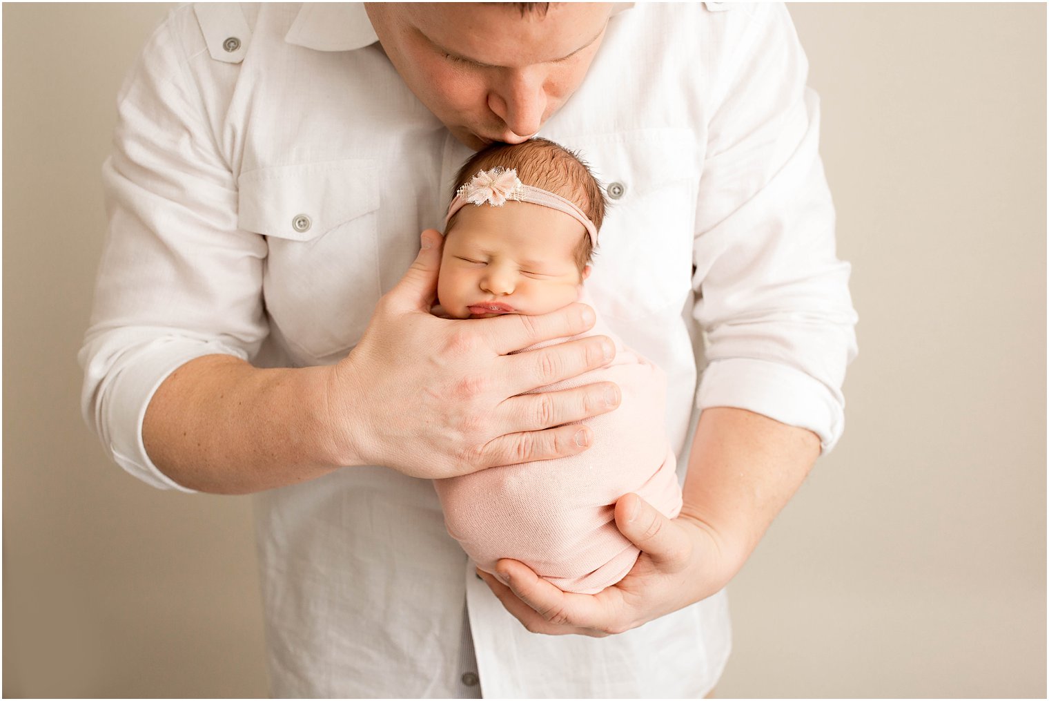 Father holding newborn girl