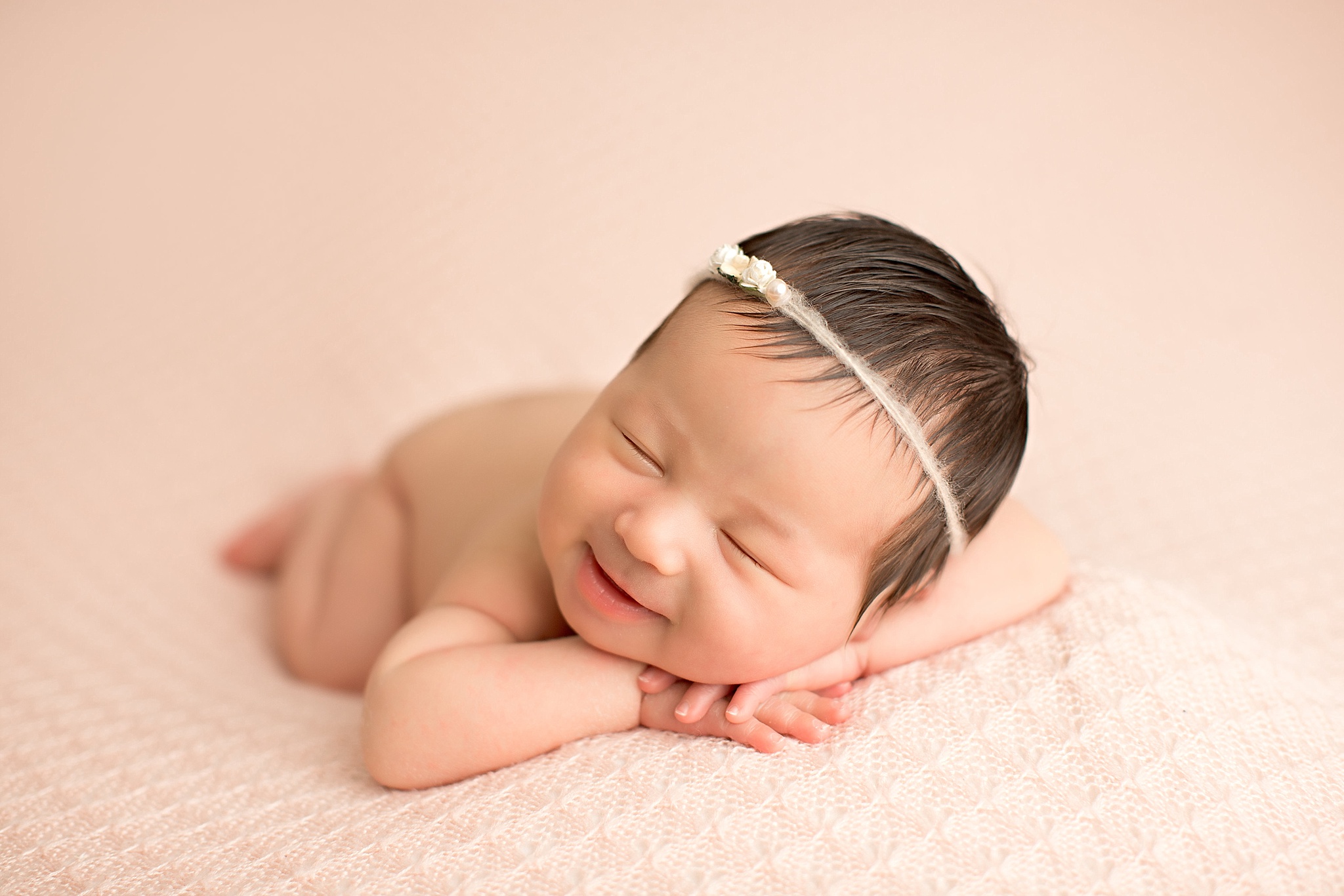smiling baby girl with tan headband