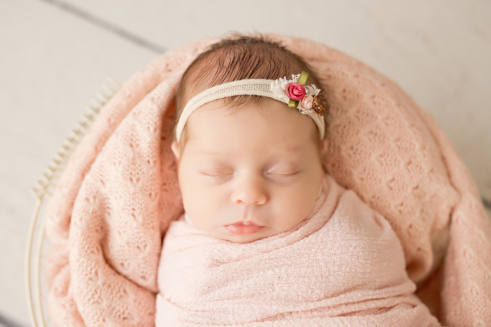 sleeping newborn girl with pink headband