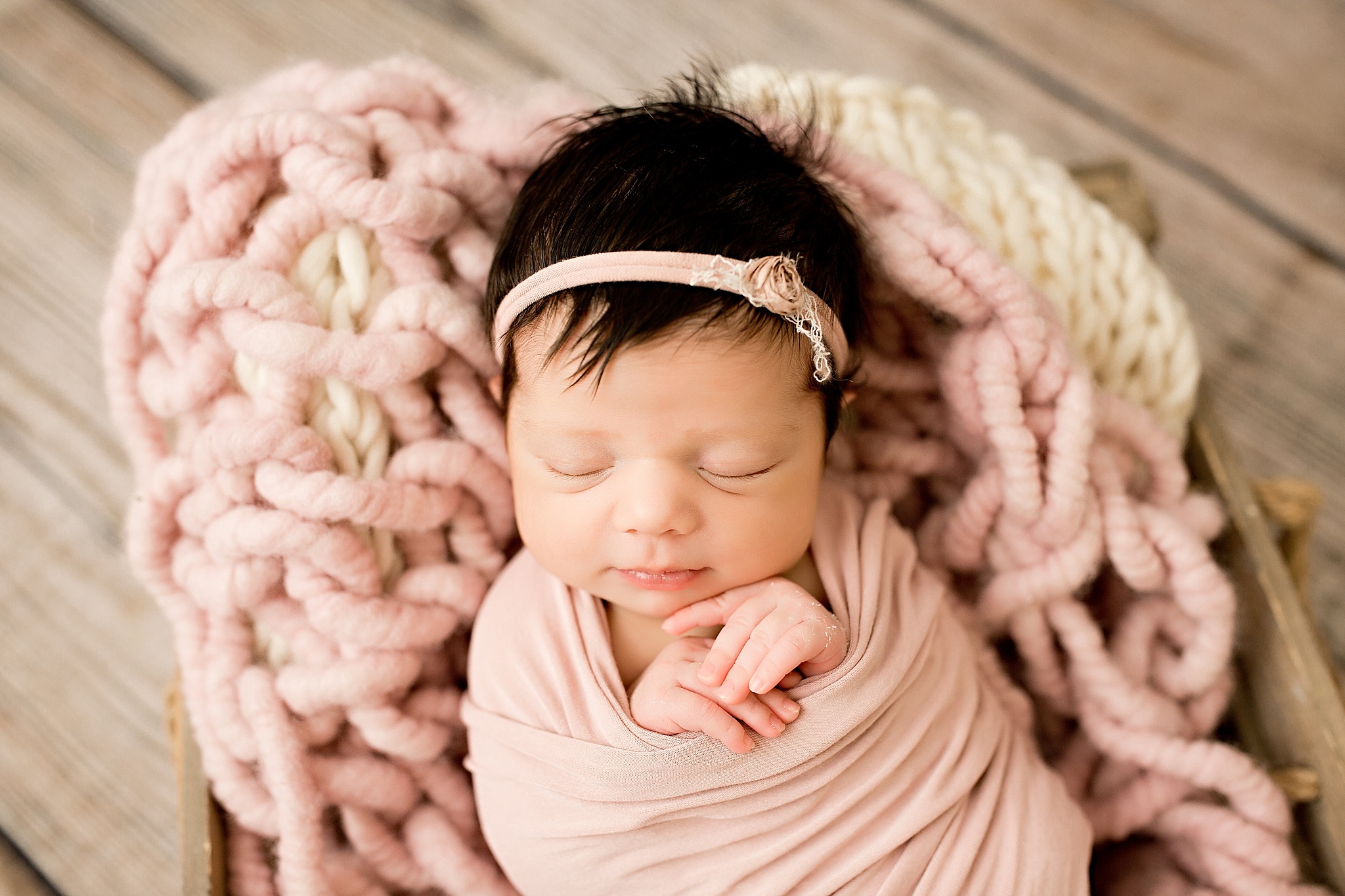 baby girl in pink blanket during studio newborn session