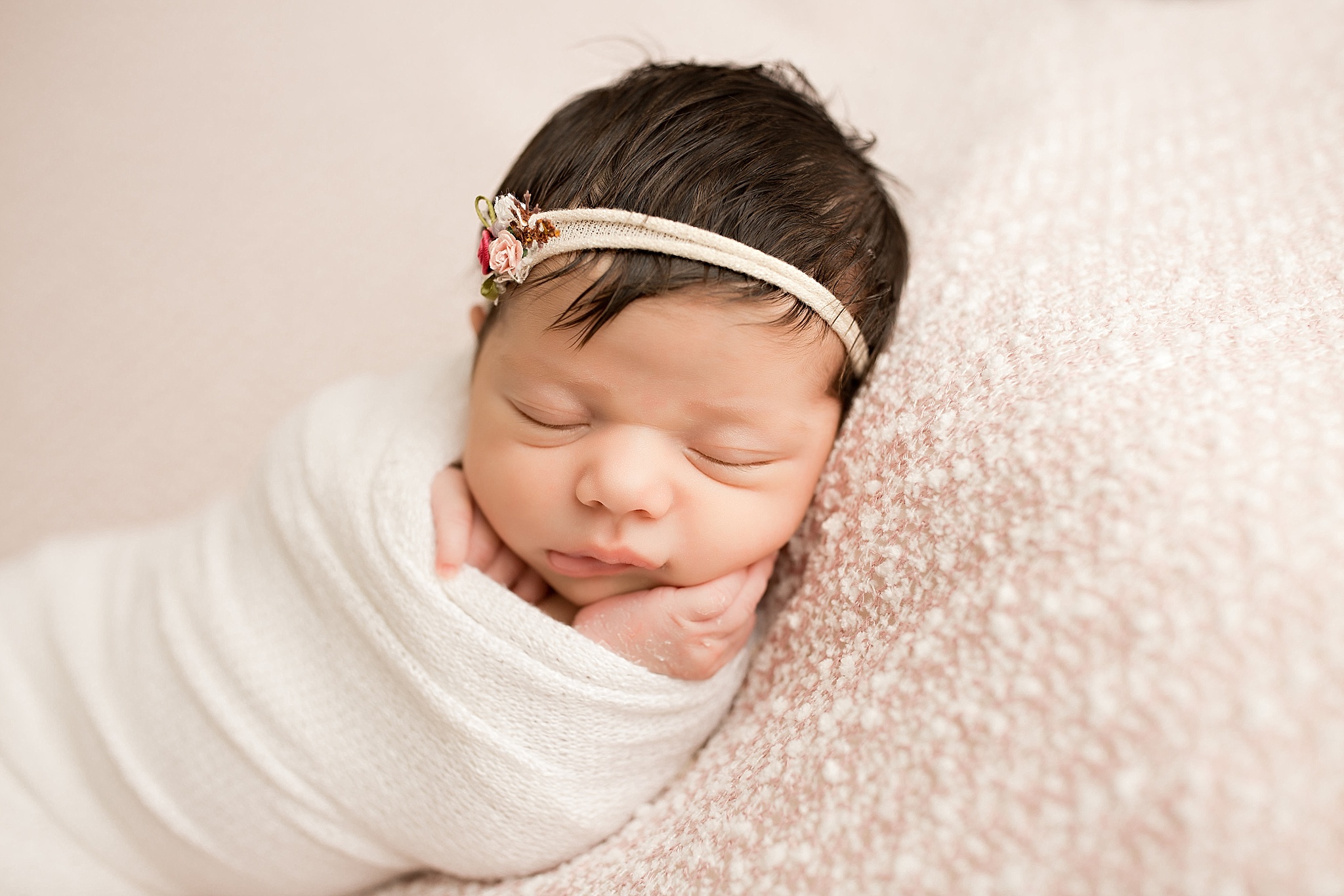 newborn baby girl sleeping with floral headband