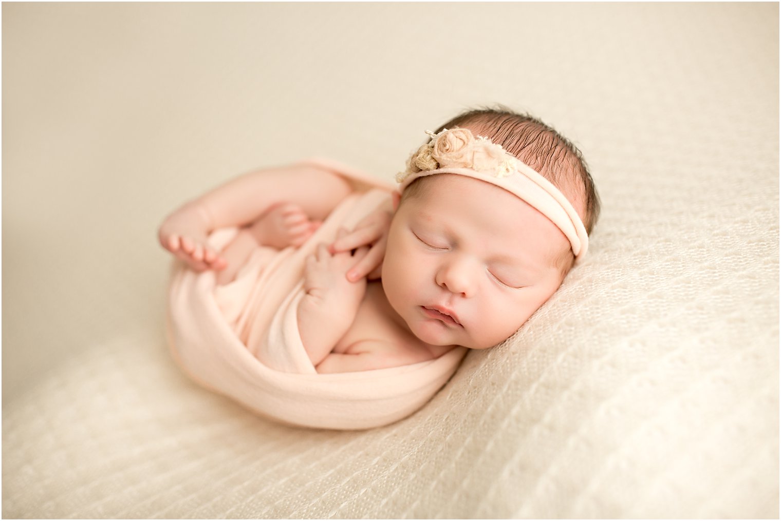 Sleeping baby girl in soft pink