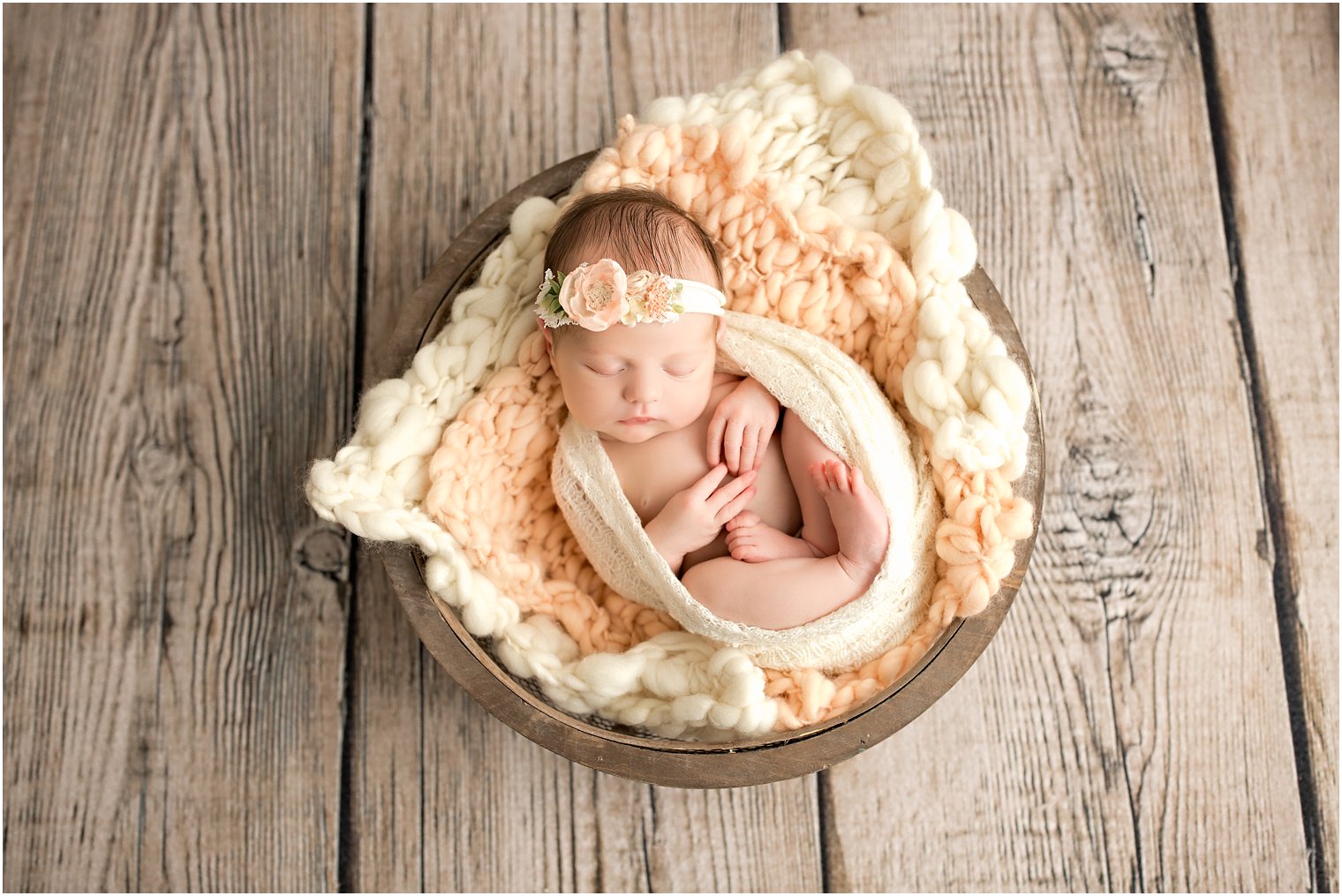 newborn girl sleeping in a basket