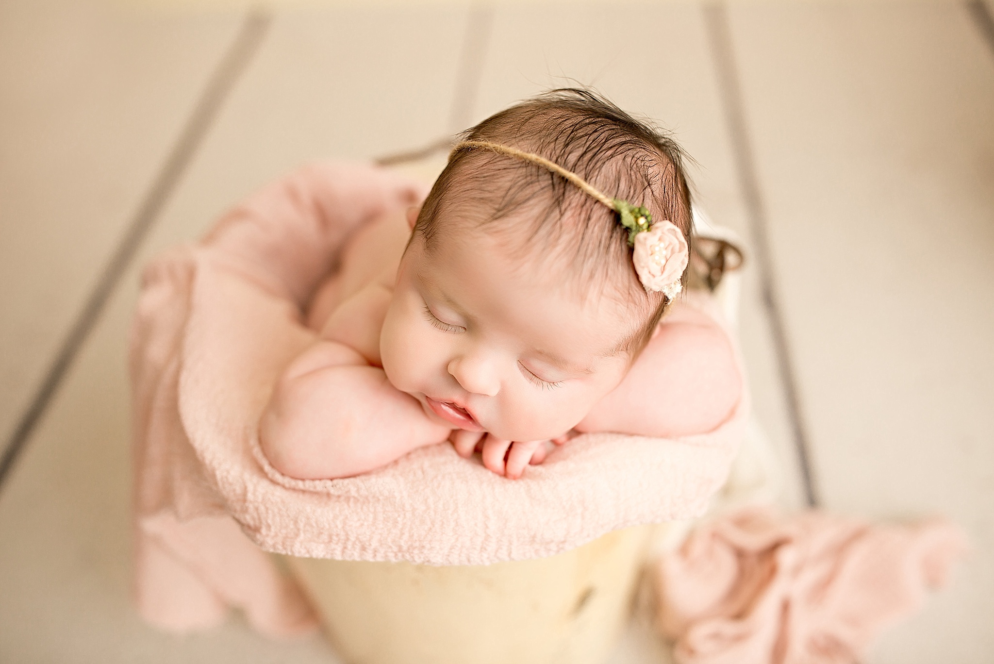 baby girl in basket during newborn session 