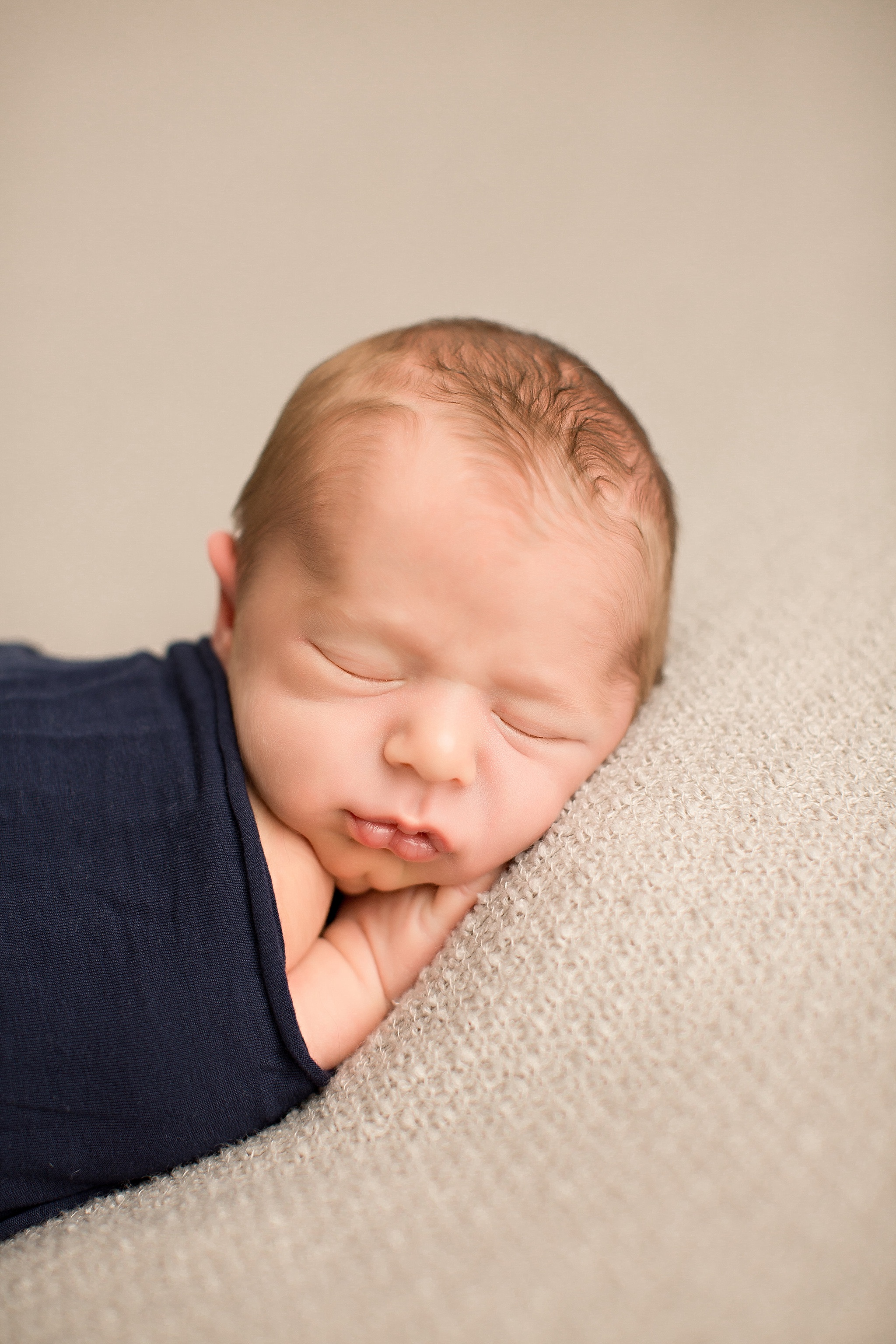 baby boy curled up sleeping during NJ newborn session