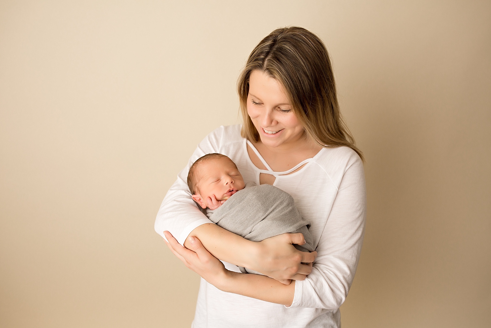 mom holds new baby boy during newborn session