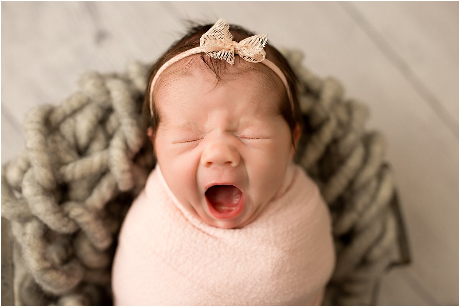 Newborn girl yawning