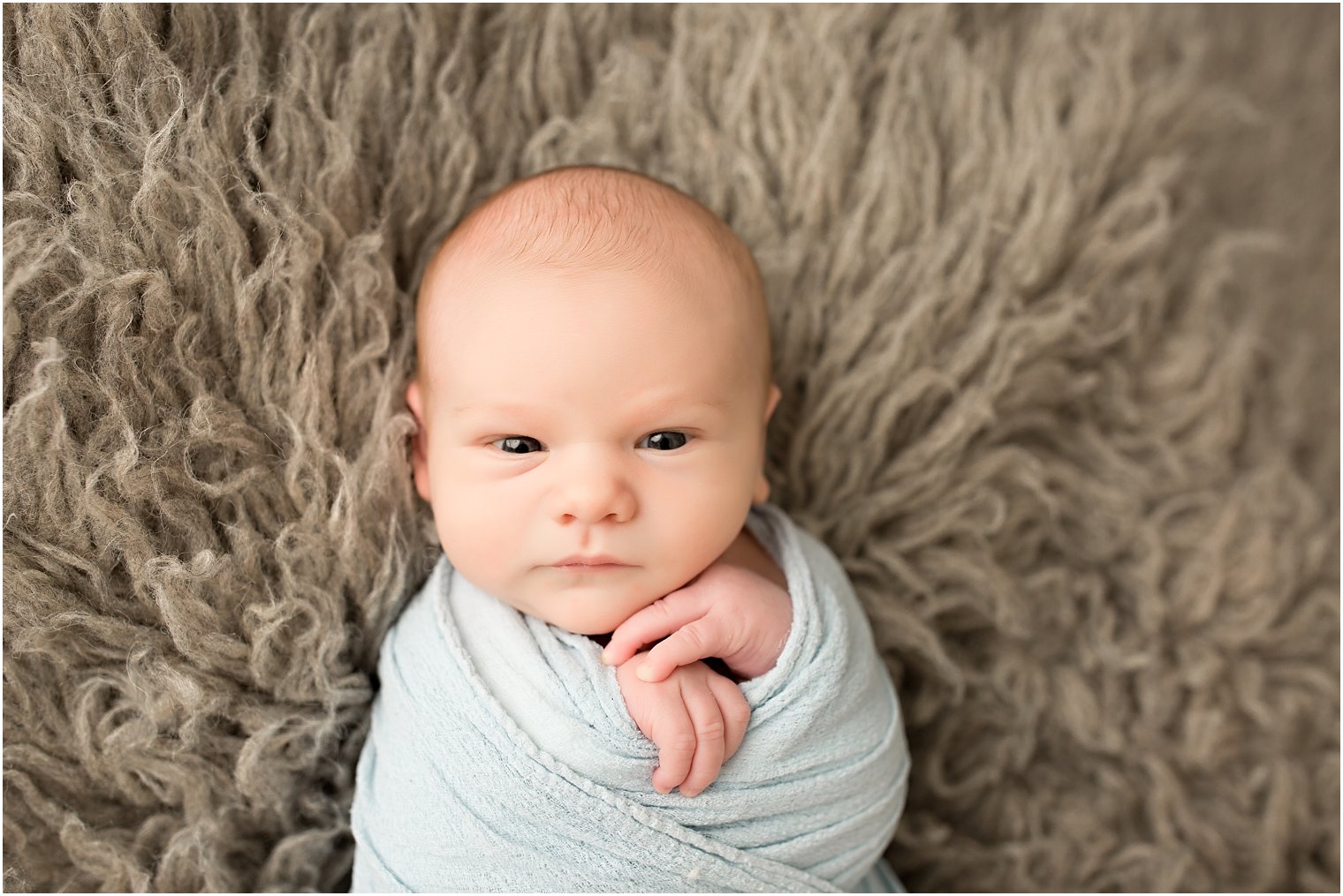 Newborn boy with his eyes open