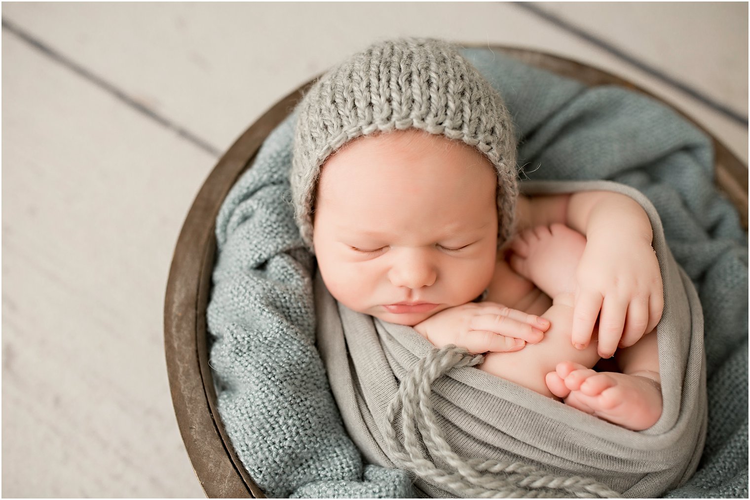newborn boy in a knit bonnet