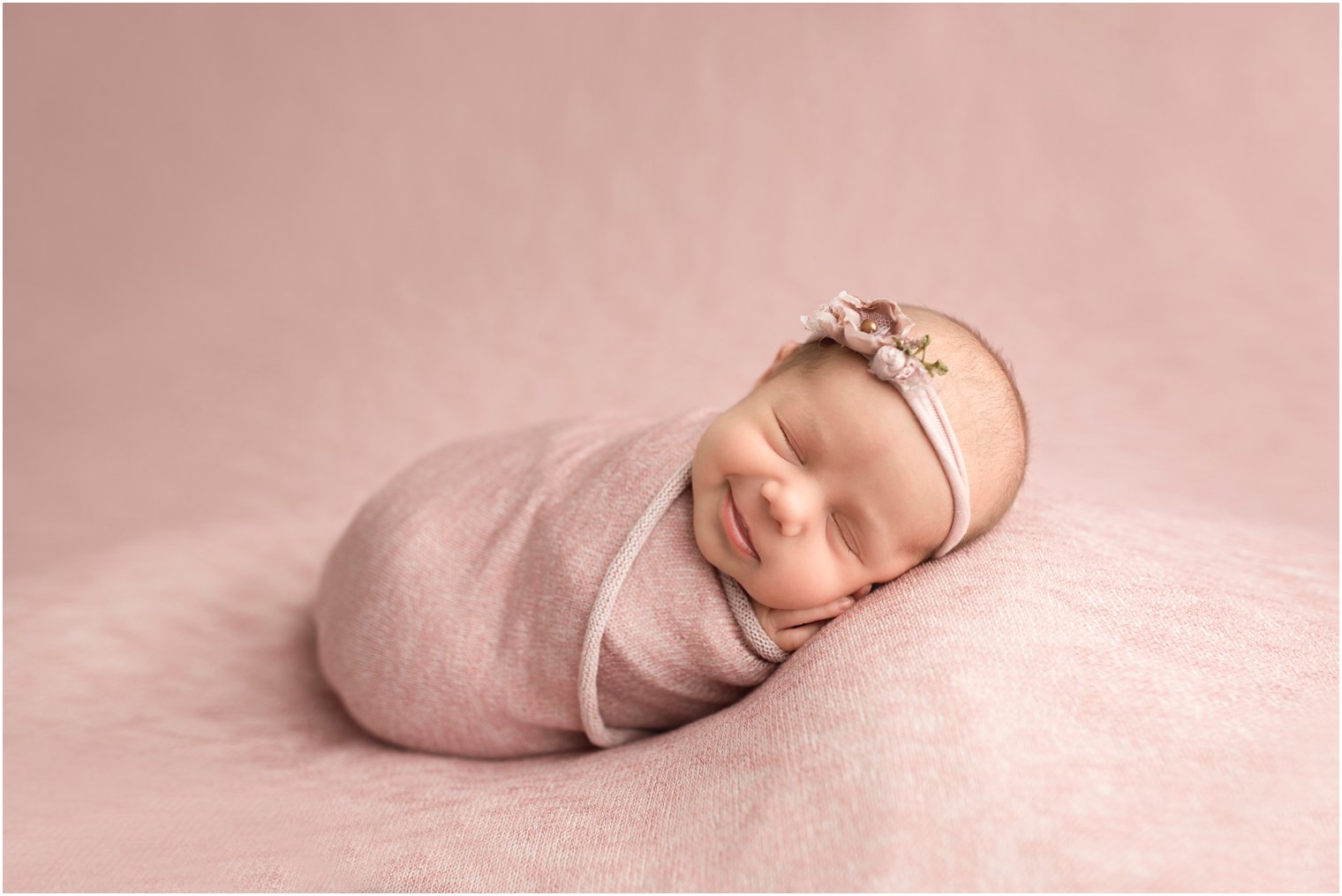 newborn girl smiling during photo shoot