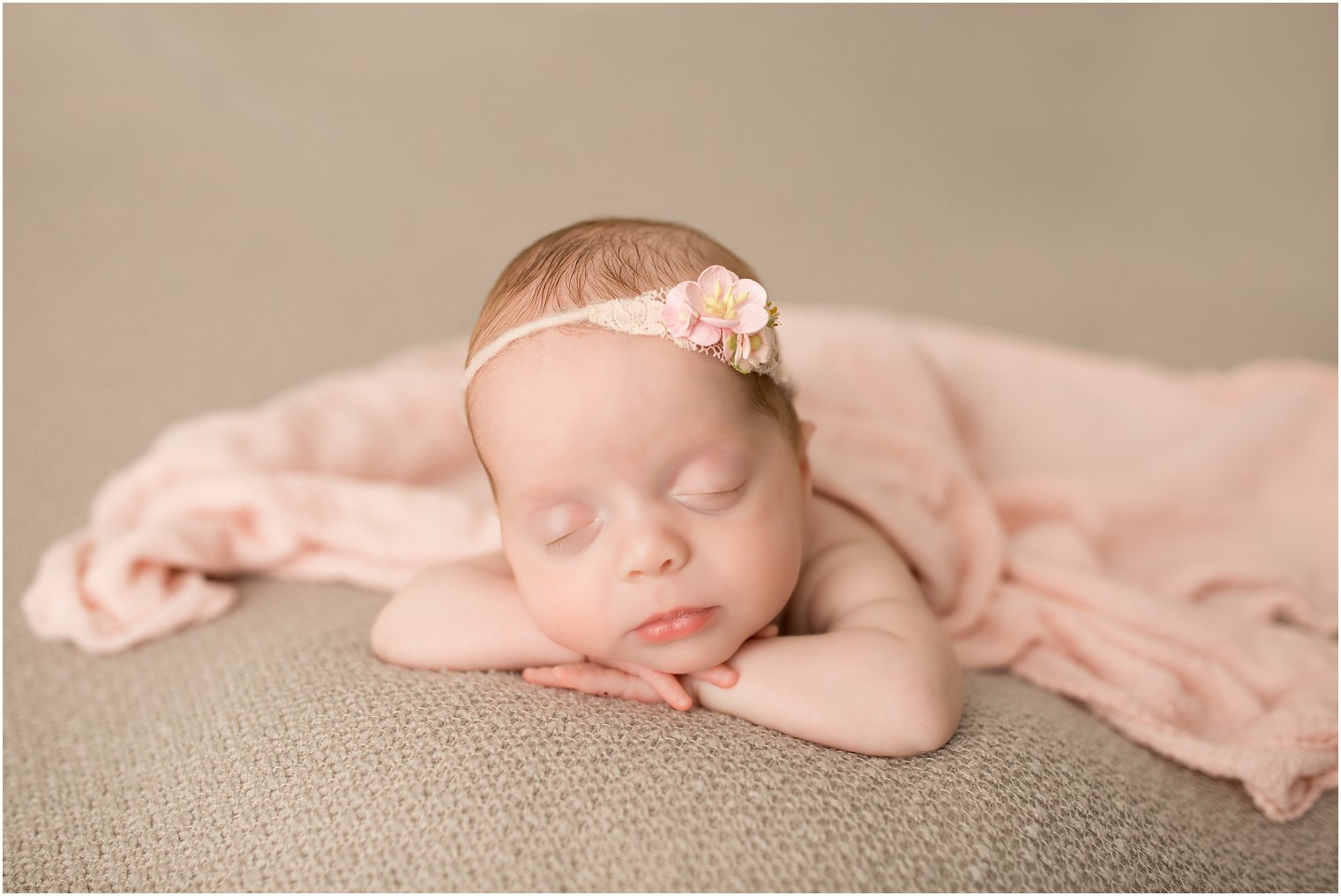 newborn baby girl in pink and gray