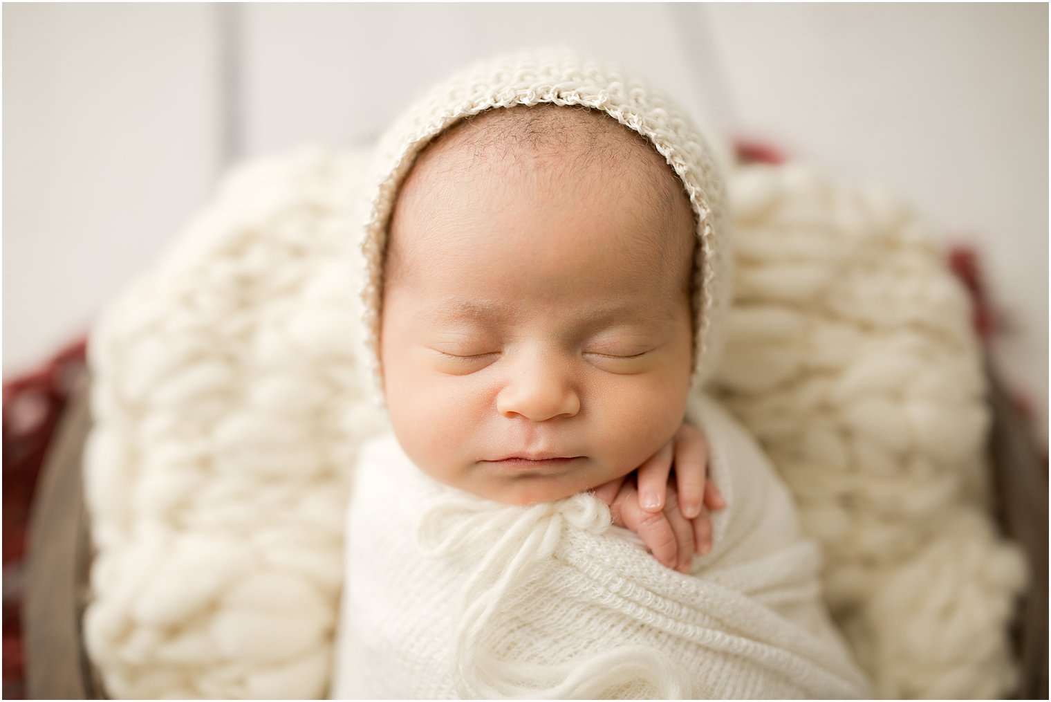 newborn girl wearing knit bonnet