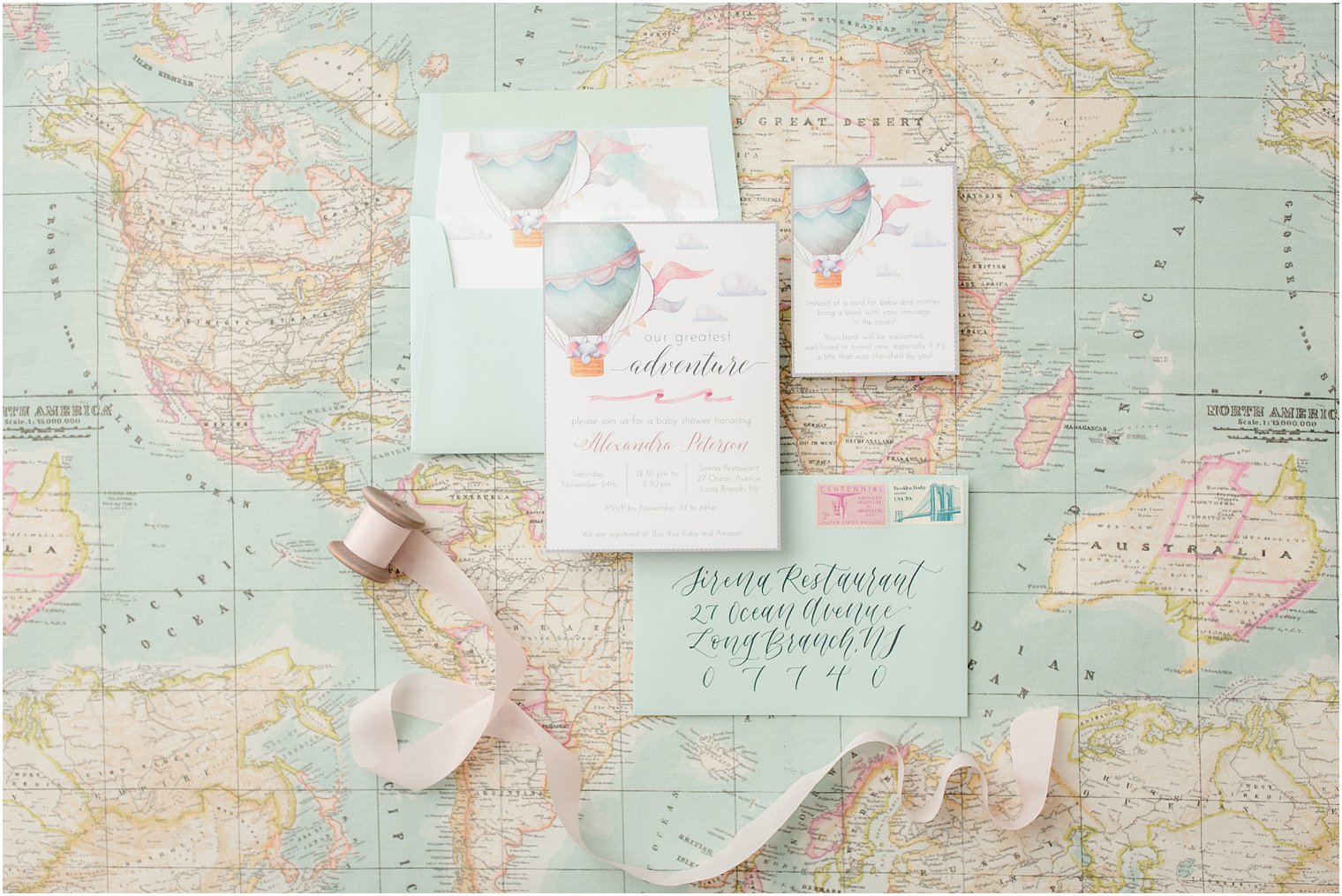 Travel-themed baby shower invitation with calligraphy 
