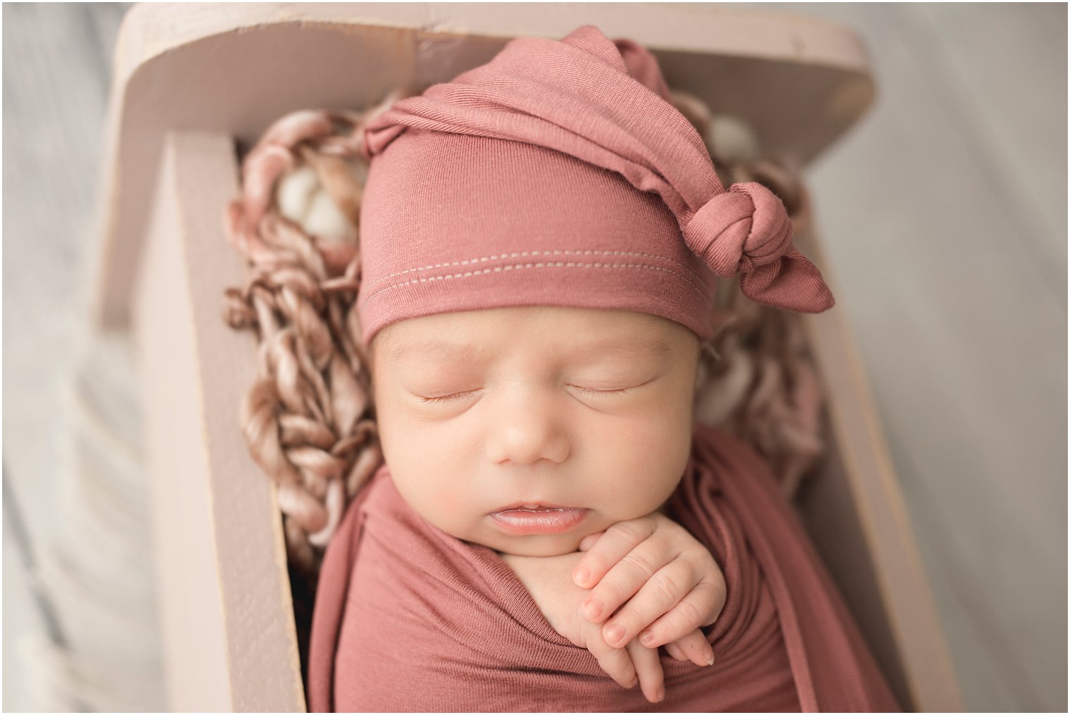 newborn girl in sleepy hat
