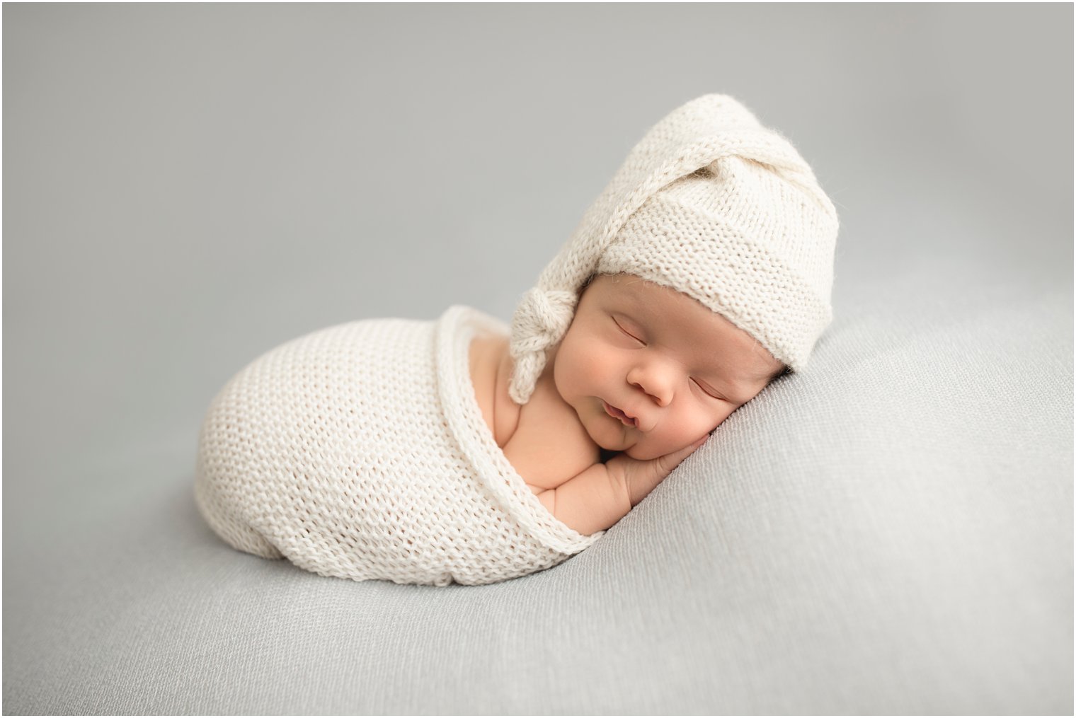 sleepy newborn boy in sleepy hat