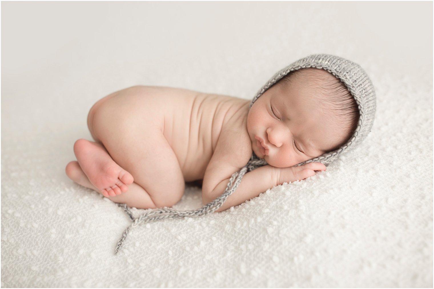 Newborn boy with gray knit hat