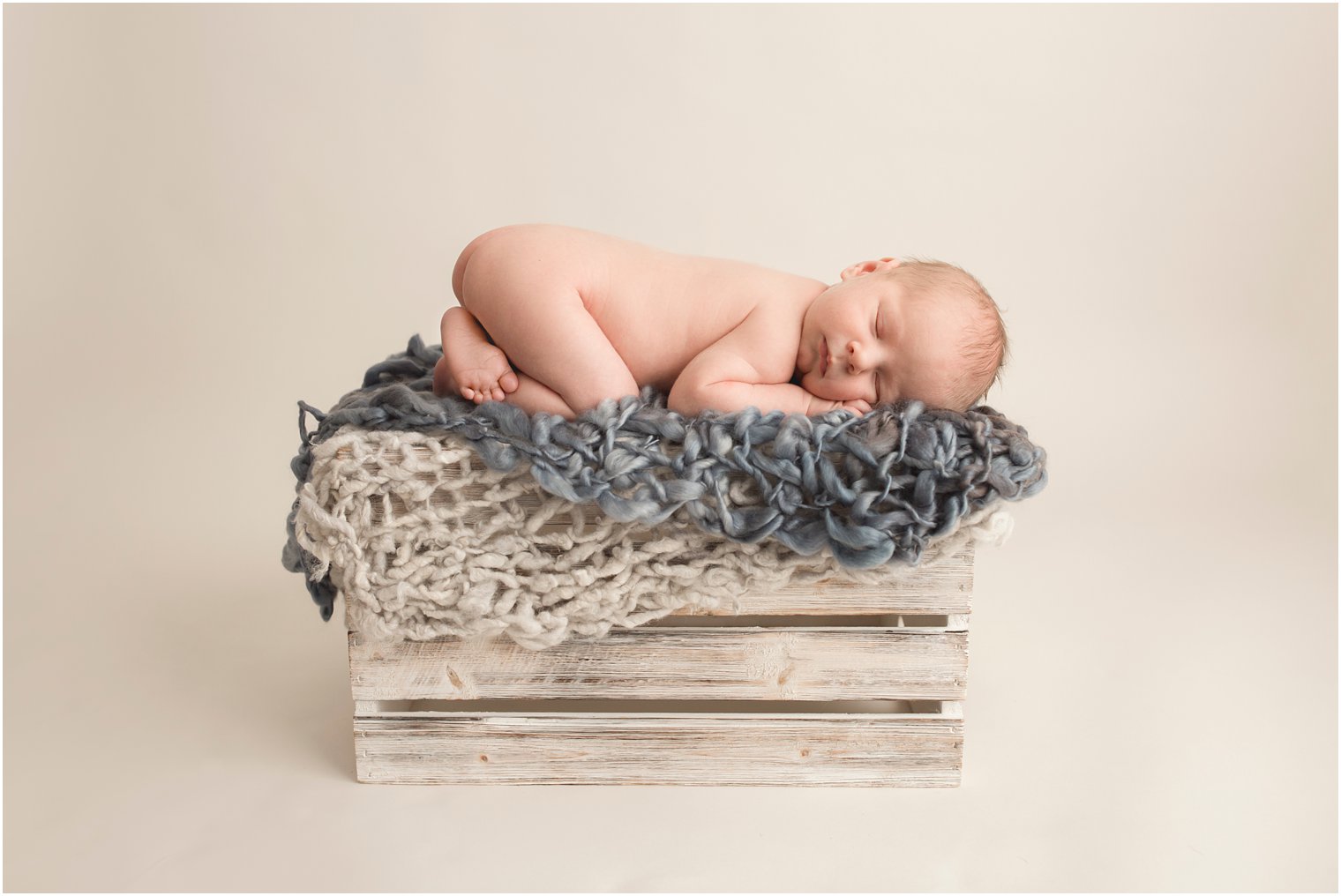 Newborn boy on a wooden crate | Red Bank NJ Newborn Photography by Idalia Photography
