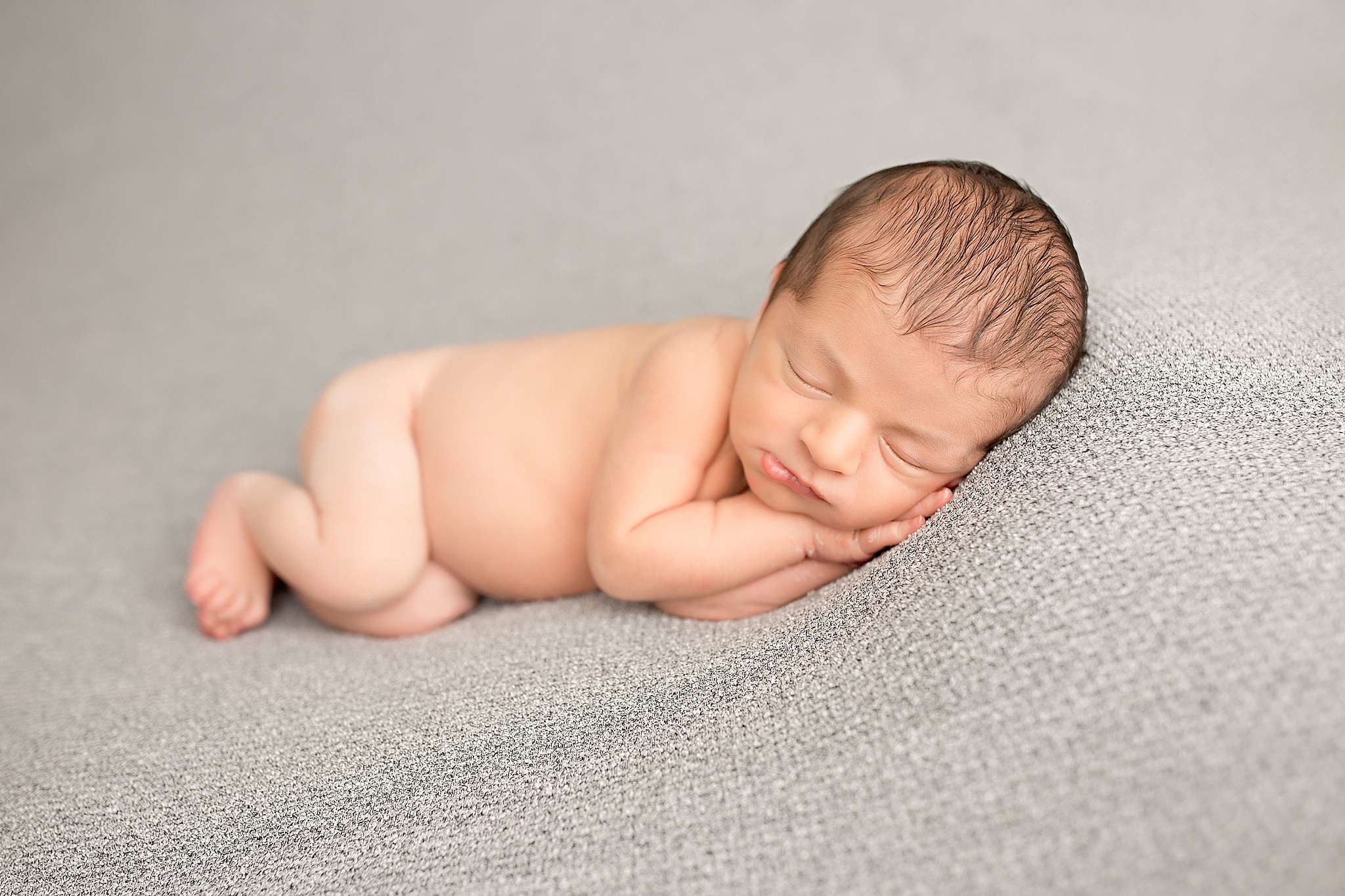 naked baby boy sleeping during newborn session