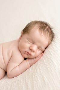 sleeping-baby-boy-on-ivory-sheet