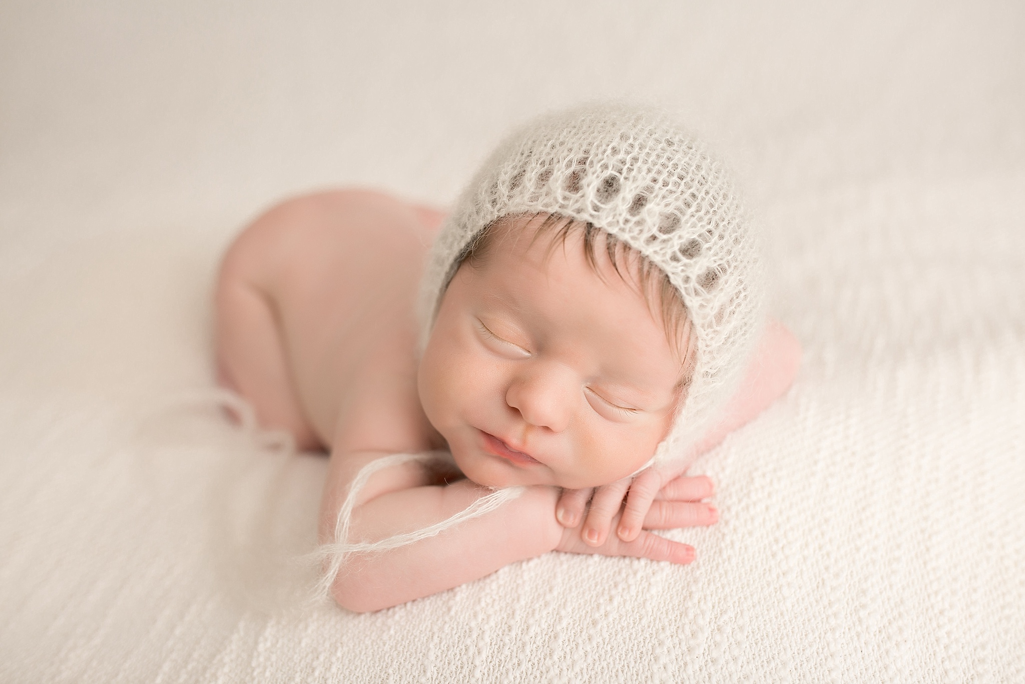 baby boy with cream knit hat