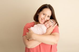 mother-holds-baby-girl-sleeping-newborn