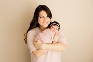 mom with new baby girl during newborn session
