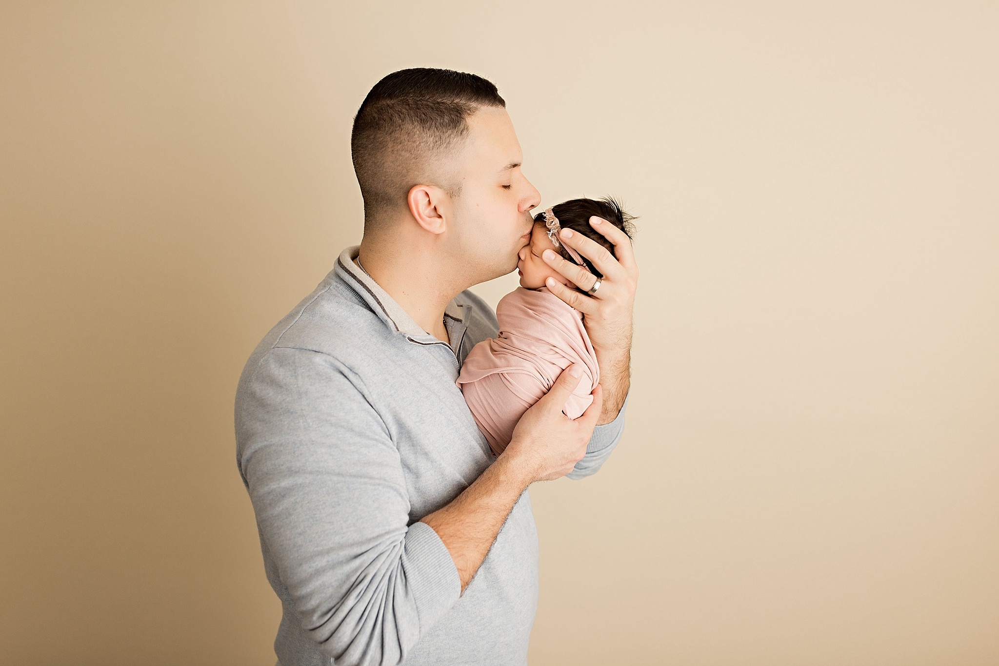new father kissing baby girl