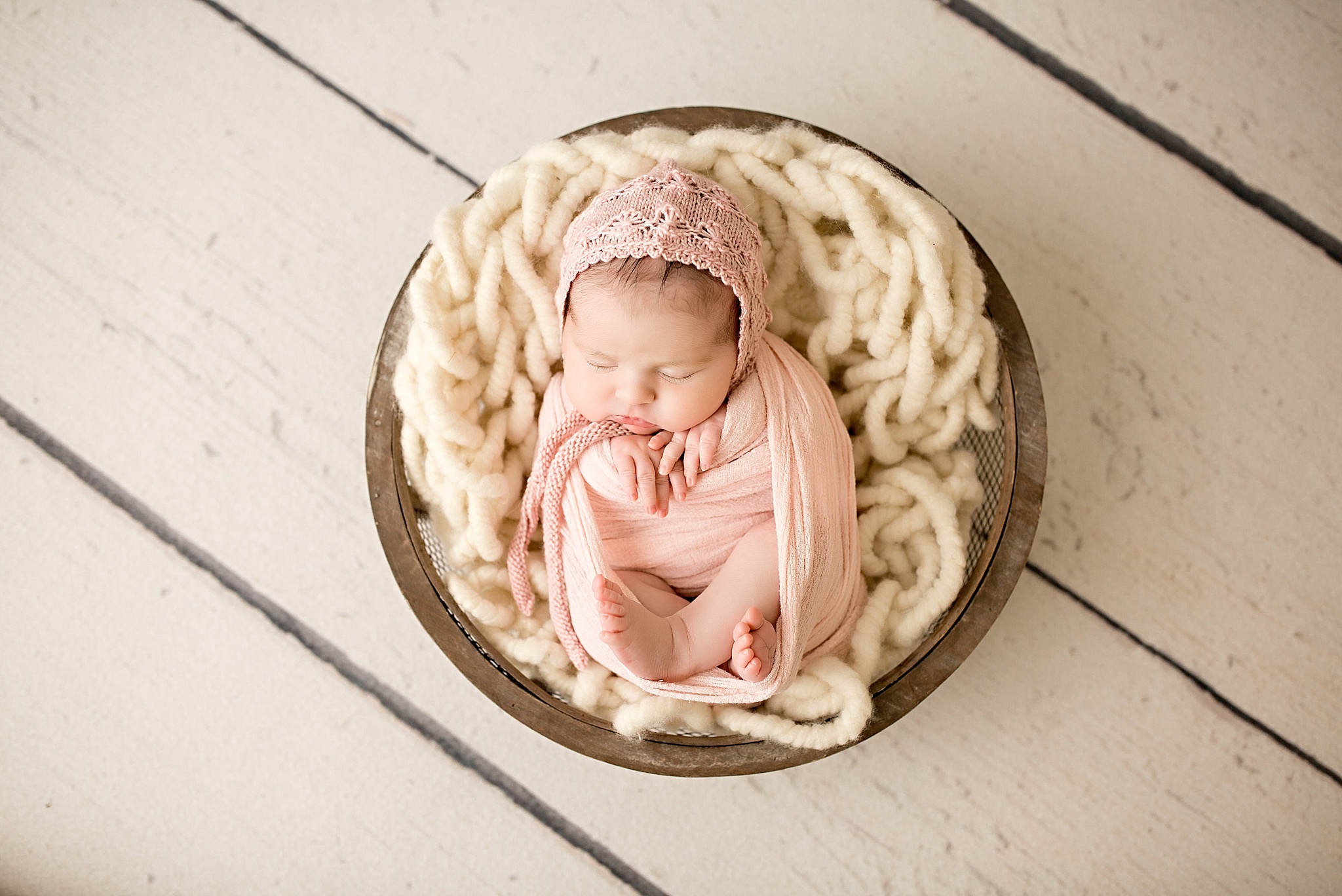 baby girl with pink knit cap during newborn session