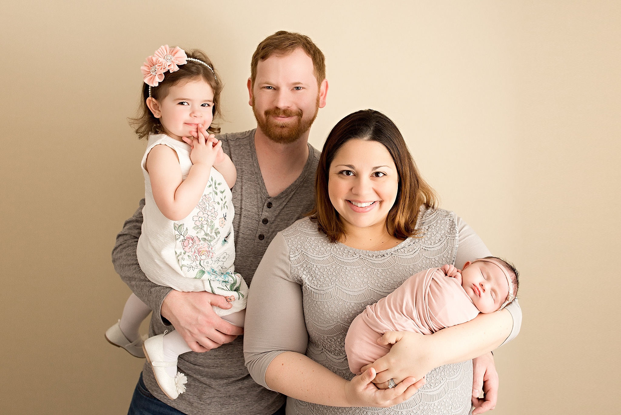 new family with precious baby girl in pink bundle