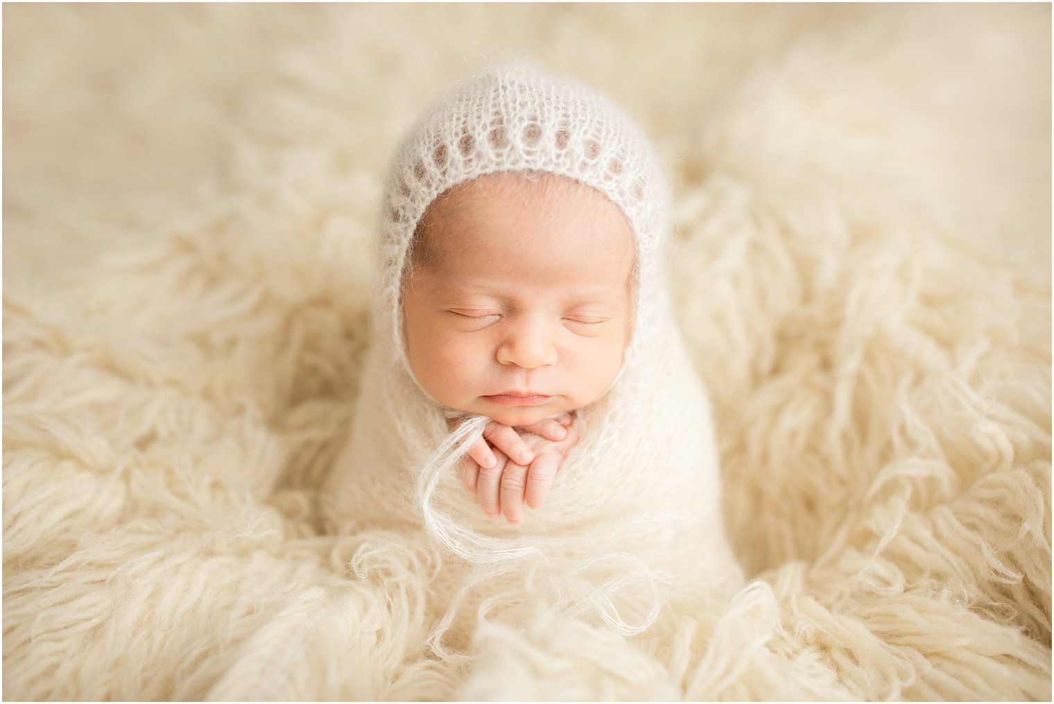 Newborn girl wrapped in ivory