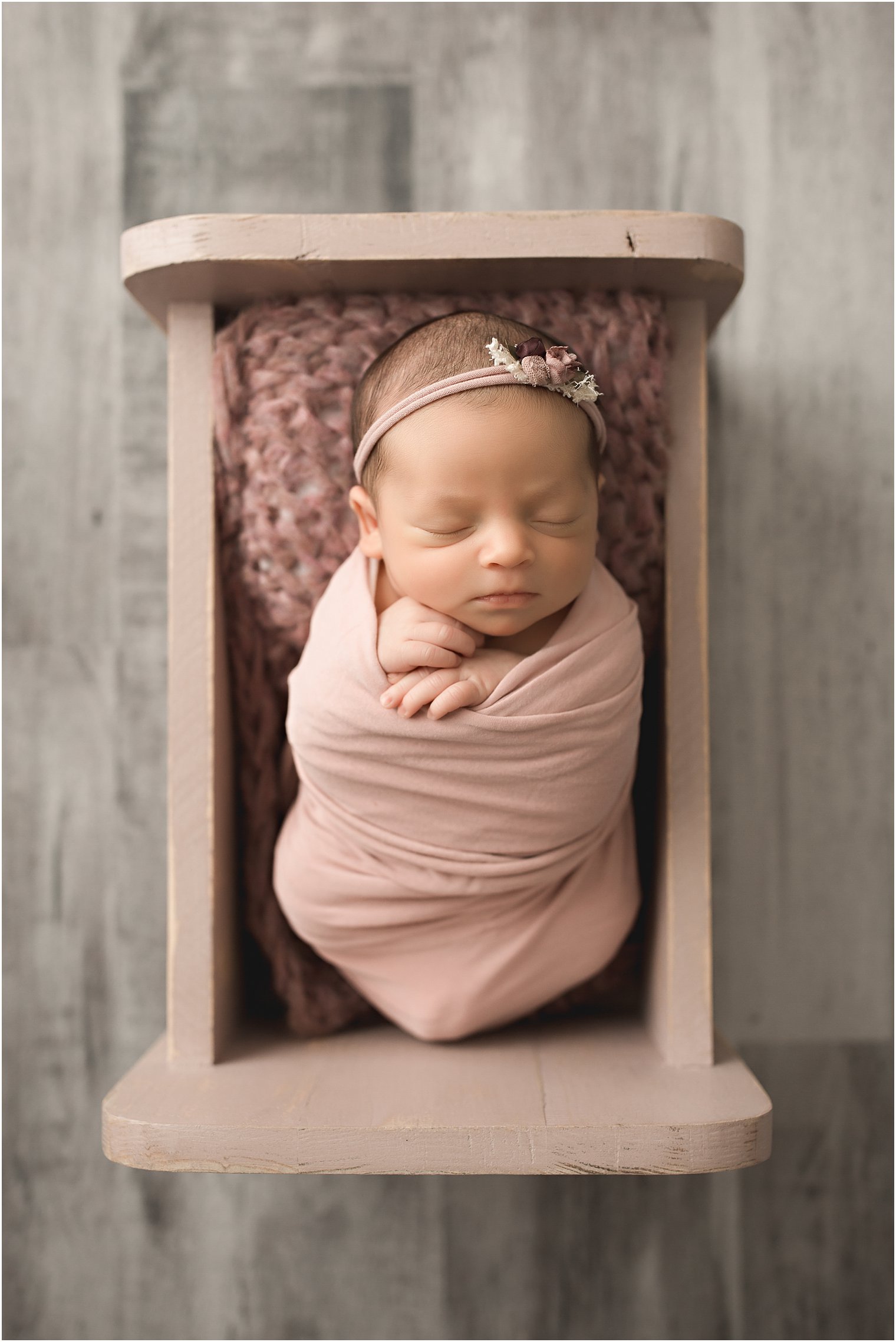Wrapped newborn session with baby in a bed | Photos by Newborn Photography