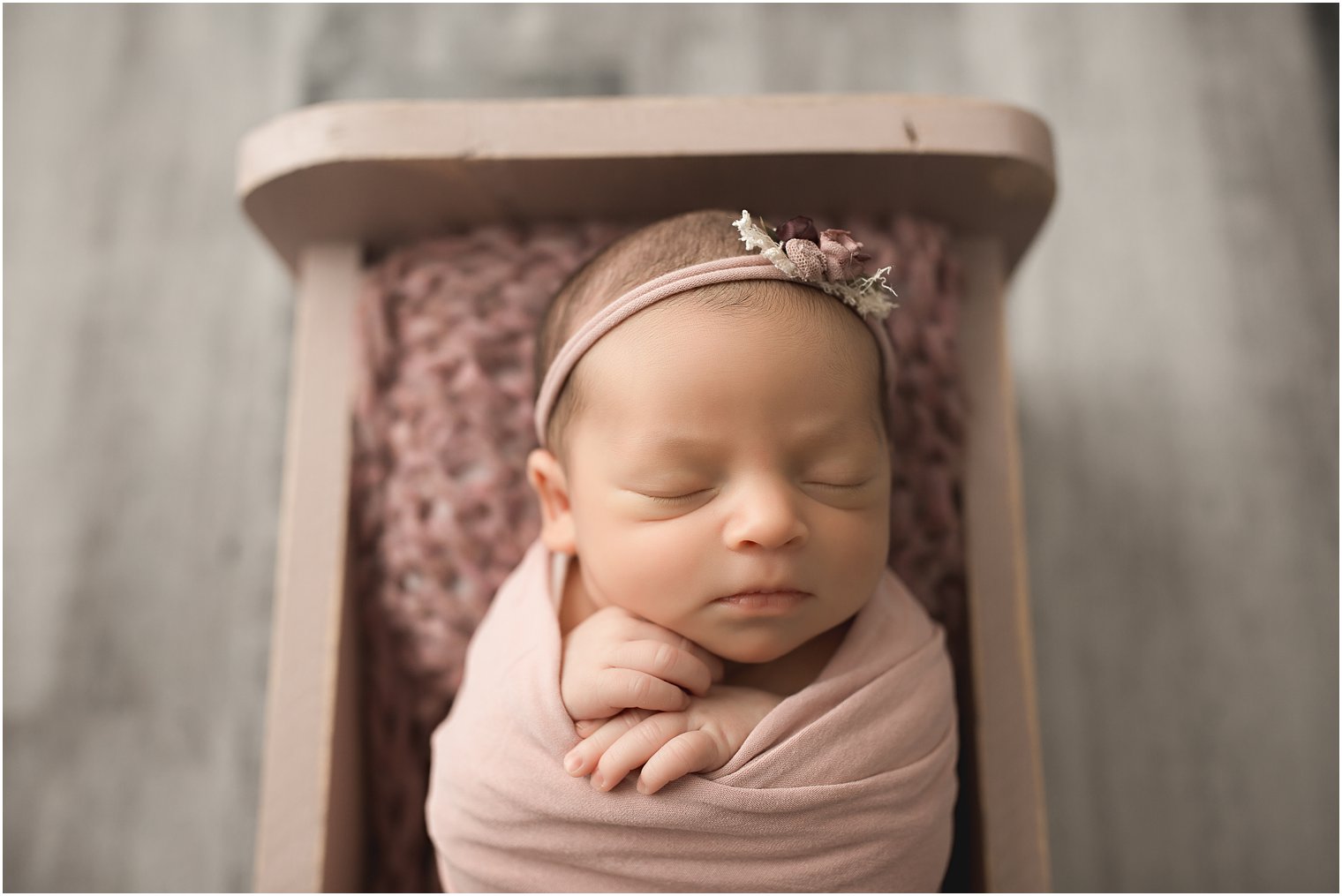 Wrapped newborn session with baby in a bed | Photos by Newborn Photography